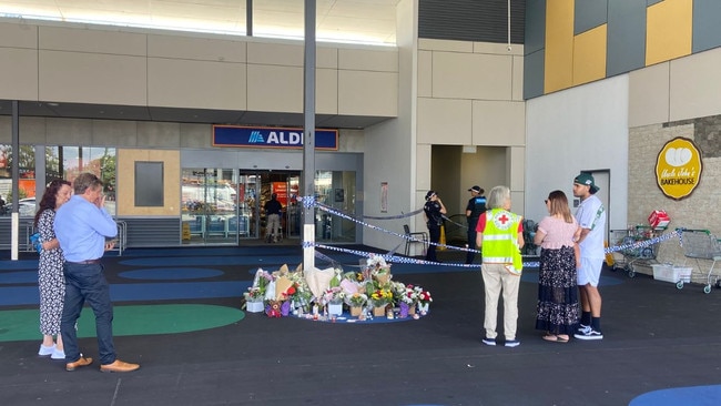 Flowers placed at the shopping centre where grandmother Vyleen White lost her life.