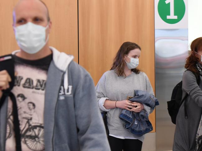 HOBART, AUSTRALIA - MARCH 19: Passengers use supplied sanitiser on arrival at Hobart airport on March 19, 2020 at Hobart airport in Hobart, Australia. The Tasmanian premier Peter Gutwein has announced all interstate travellers will be required to quarantine for 14 days. The measures are the toughest to be imposed in Australia, and will come into effect from Friday 20 March. There are now 596 confirmed cases of COVID-19 In Australia, while there have been six confirmed deaths, five in NSW and one in Western Australia. (Photo by Steve Bell/Getty Images)