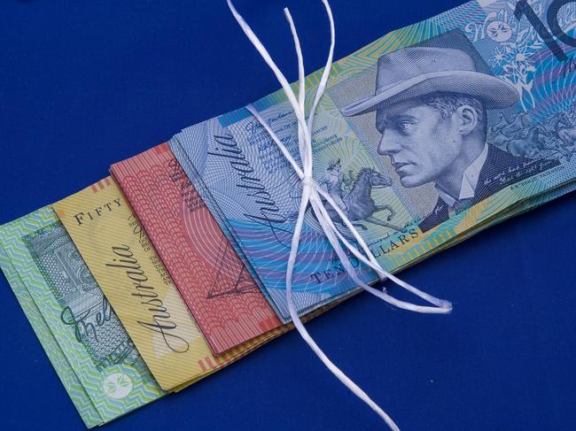 YOUR MONEY Australian cash tied in string. currency / cash / mortgage / bills / savings / bundle