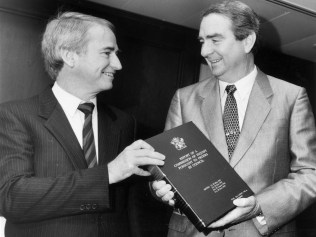 Commissioner Tony Fitzgerald hands his report to then Queensland premier Mike Ahern in 1989. Picture: Supplied.