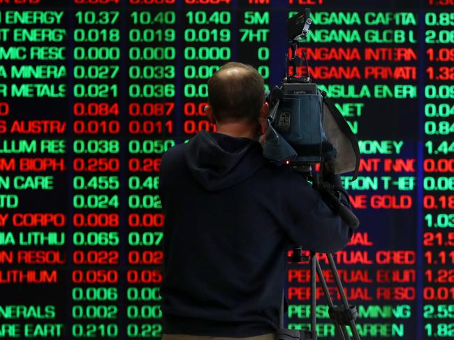 SYDNEY, AUSTRALIA - AUGUST 06: A TV camera person records electronic boards displaying stock information at the Australian Securities Exchange, operated by ASX Ltd. on August 06, 2024 in Sydney, Australia. The markets are closely attuned to the RBA's next rates decision, with inflation persisting even as rates have been elevated for an extended time after the end of the COVID-19 pandemic. (Photo by Lisa Maree Williams/Getty Images)