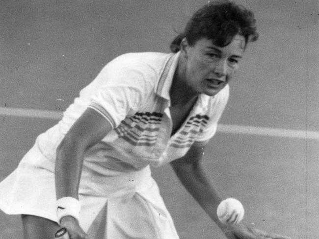 Liz Smylie volleys during her tennis career.