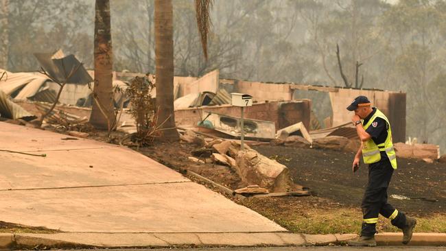 A NSW Hazardous Materials Unit fireman surveys damage in the suburb of Catalina, near Batemans Bay. Picture: Sam Mooy/The Australian