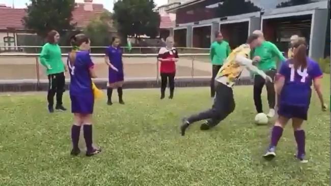 The moment NSW Sports Minister John Sidoti faceplants while having a game of soccer with students. Picture: Supplied