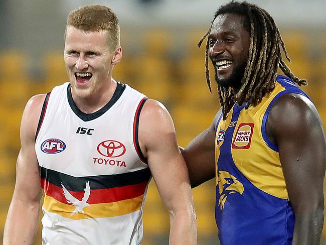 BRISBANE, AUSTRALIA - JULY 11: Reilly O'Brien of the Crows and Nic Naitanui of the Eagles share a joke at the end of the match during the round 6 AFL match between the West Coast Eagles and the Adelaide Crows at The Gabba on July 11, 2020 in Brisbane, Australia. (Photo by Jono Searle/AFL Photos/via Getty Images)