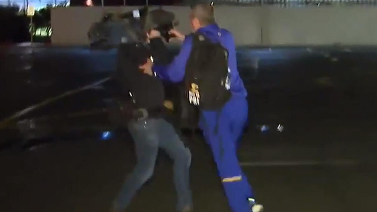 A screengrab of a West Coast official pushing a cameraman.