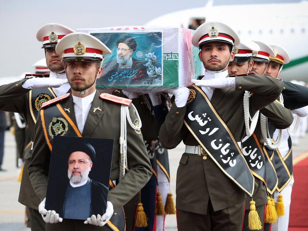 This handout picture provided by the Iranian president's office shows honour guards carrying the coffin of late president Ebrahim Raisi during a funeral procession. Picture: AFP