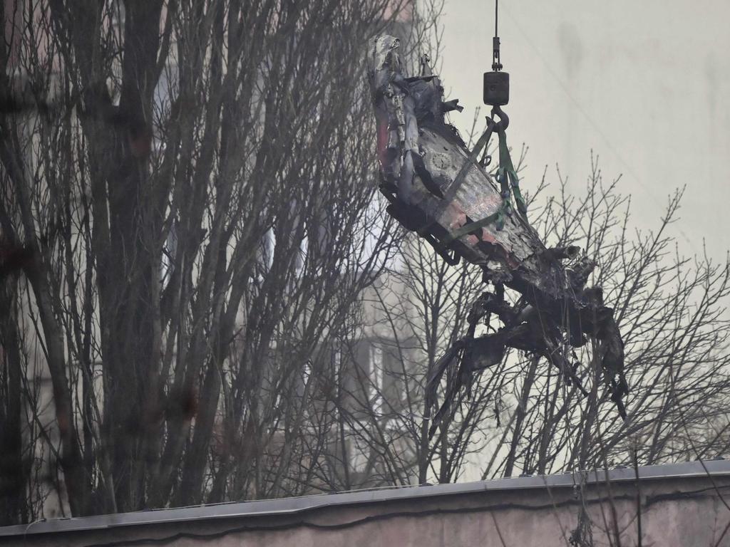 A part of a helicopter that crashed near a kindergarten is removed in Brovary. Picture: AFP)