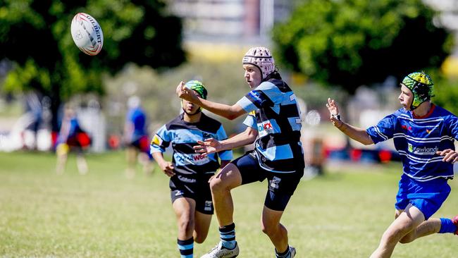 Day One of King of the Country rugby tournament at James Overell Park, Southport. Maroochydore Swans U14s' ( big stripes - blue) in action against USQ Saints U14s' (darker blue small stripes). Maroochydore Swans U14s' Jarvis Wood. Picture: Jerad Williams