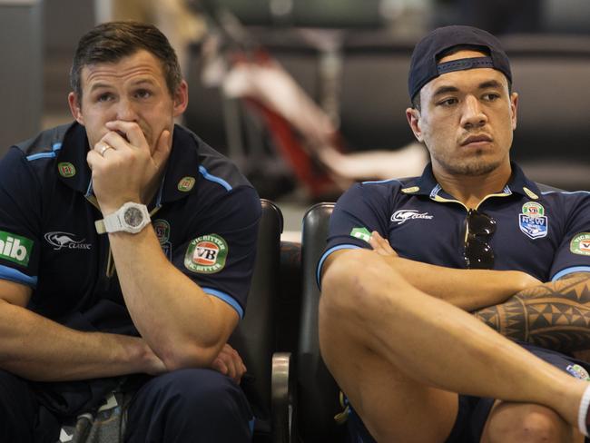 Blues Brett Morris and Tyson Frizell wait for their luggage at Sydney airport. Picture: Jenny Evans