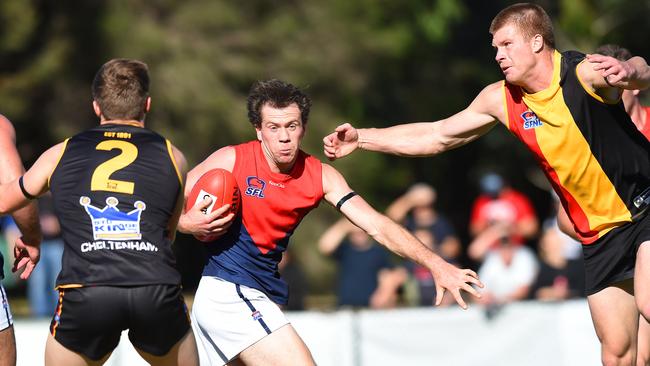 Bentleigh's Sean Scotland evades Cheltenham's Sean McLaren in the Anzac Day match at the Jack Barker Oval.