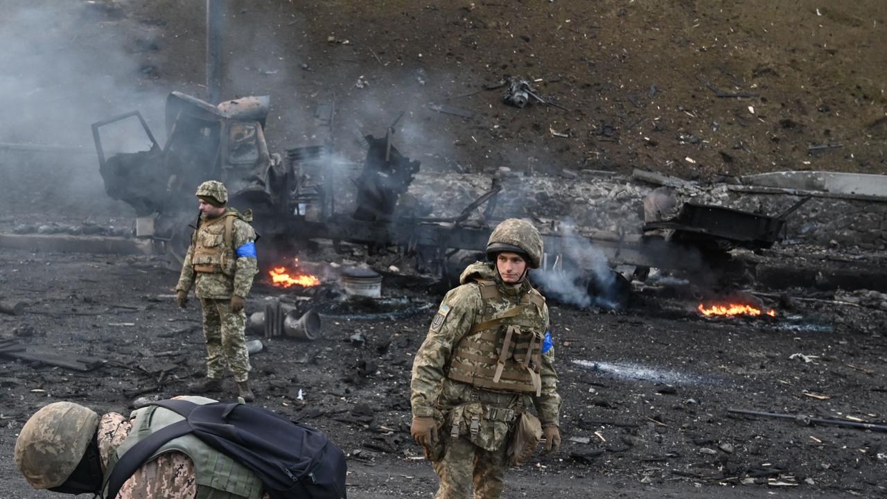 Ukrainian service members look for unexploded shells in Kyiv. Picture: Sergei Supinsky/AFP