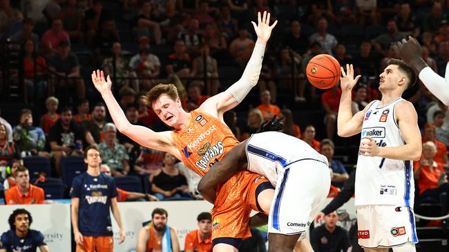 Adelaide's Montrezi Harrell lands awkwardly on Taipans' Sam Waardenburg after he fakes a shot in the National Basketball League (NBL) match between the Cairns Taipans and the Adelaide 36ers, held at the Cairns Convention Centre. Picture: Brendan Radke