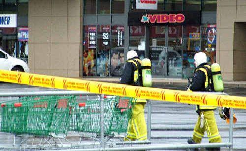 On the job: Firemen with breathing apparatus tackle the fire at Ballina Fair shopping centre yesterday. Picture: Rebecca Lollback