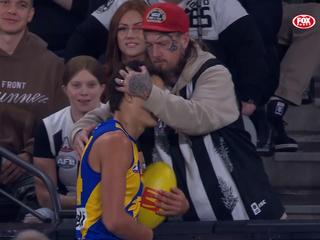 Harvey Johnston is touched by a Collingwood fan