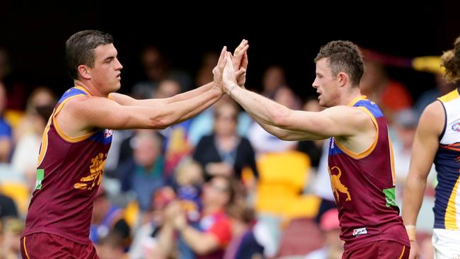 Tom Rockliff and Pearce Hanley after a goal against West Coast Eagles. Both have now departed the Lions. Picture: Darren England.