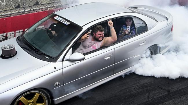 It turns out doing a burnout will cost you less in fines than playing an instrument in the car. Picture: NewsLocal/Martin Ollman