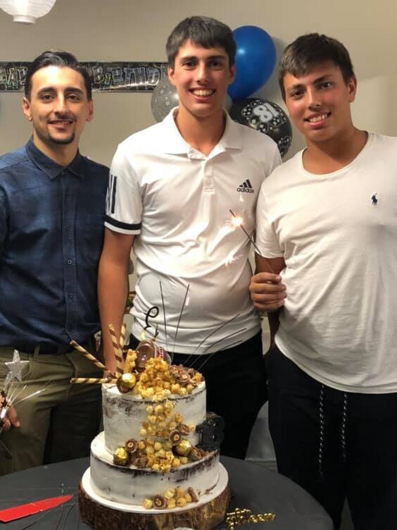 Christopher (centre) celebrating his 18th birthday with brothers Adriano (left) and Michael two days before he sustained fatal injuries at work. Picture: Facebook