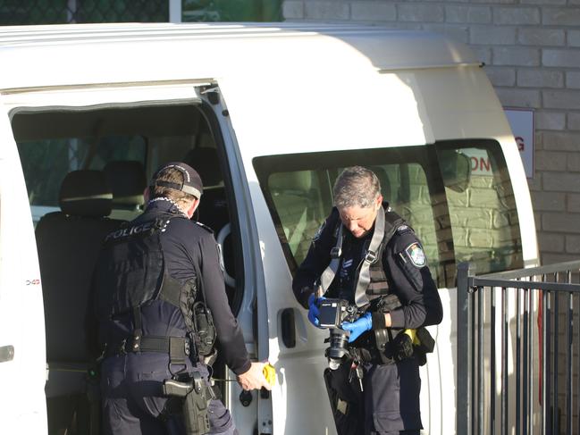 Police at the childcare centre in Gracemere where a child was found in critical condition on a parked bus - Photo Steve Vit