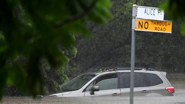 Flash flooding has closed dozens of roads across Brisbane, the Gold Coast and Sunshine Coast. Picture, John Gass