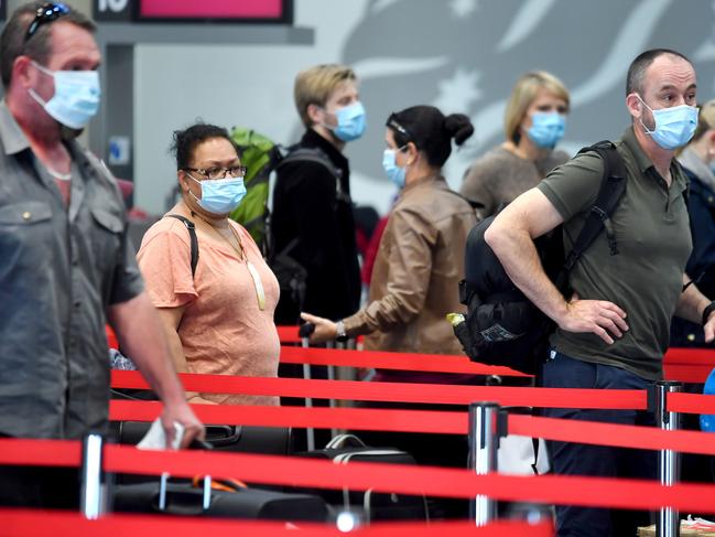 BRISBANE, AUSTRALIA - NewsWire Photos JUNE 28, 2021: Travelers arrive at the Brisbane Airport with masks on as Queensland authorities announce even tougher Covid-19 restrictions.Picture: NCA NewsWire / John Gass