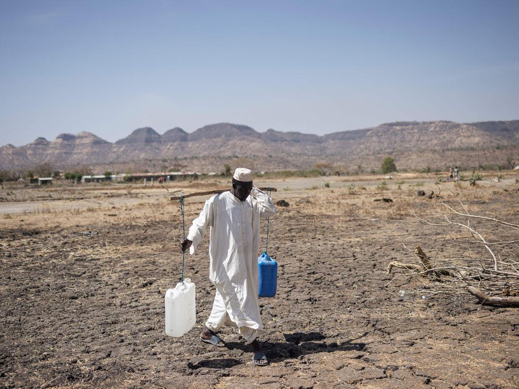 A Sudanese refugee returns from water collection at Awulala camp, near Maganan, Ethiopia, amidst conflict and unrest in the Amhara region. Picture: Michele Spatari/AFP