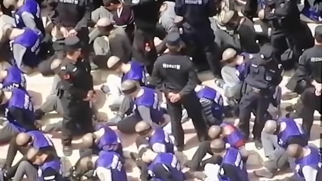 Blindfolded and shackled Uighurs in China’s Xinjiang Province. Picture: YouTube