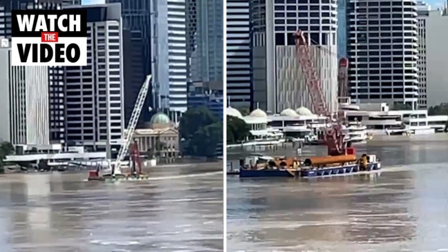 Runaway 550-tonne barge continues floating in Brisbane River