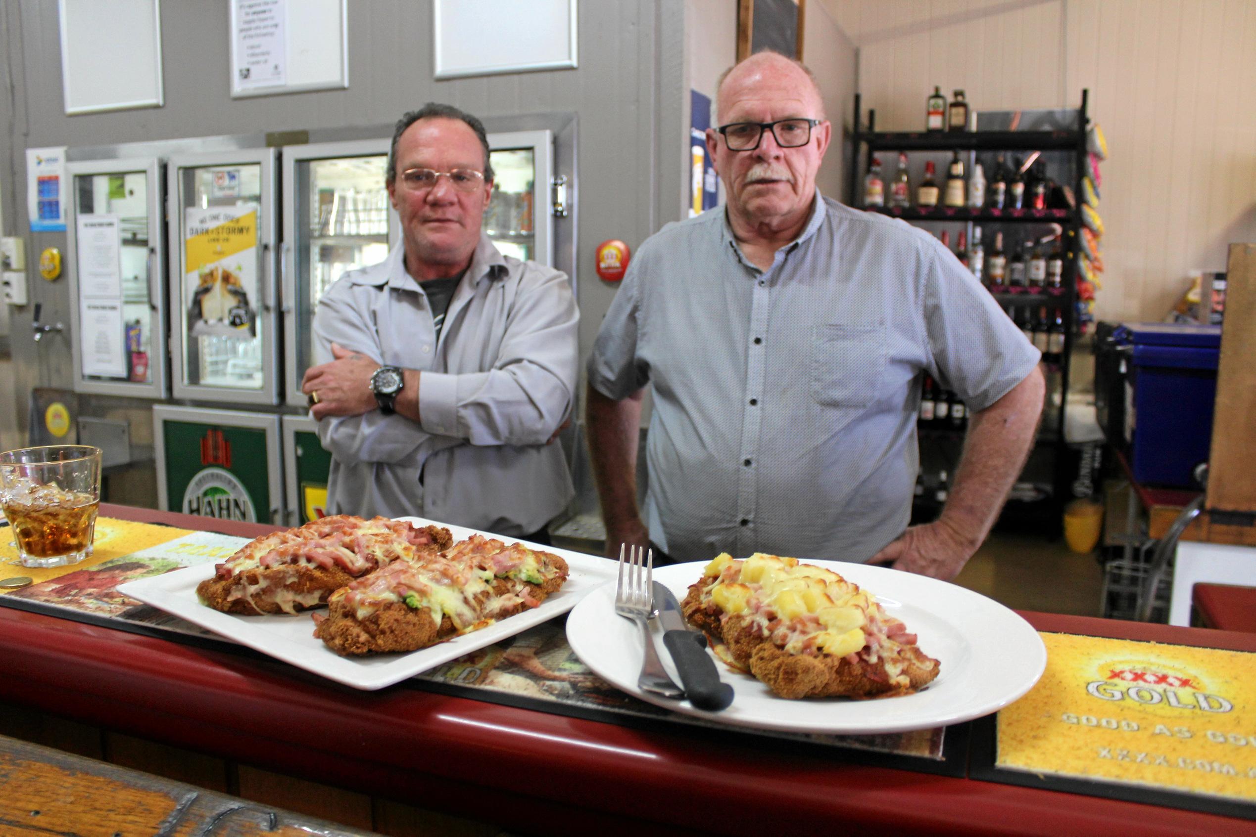 Bartender Kev Newcombe and Manger Rod Bullock eyeing off the chicken Parmies served up at the Royal Hotel in Yarraman. Picture: Laura Blackmore