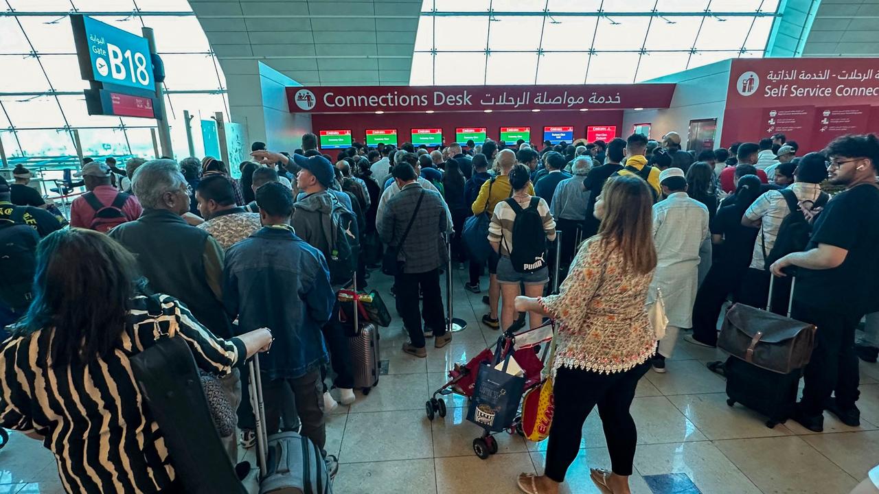 Passengers queue at a flight connection desk at the Dubai International Airport in Dubai on April 17. Picture: AFP