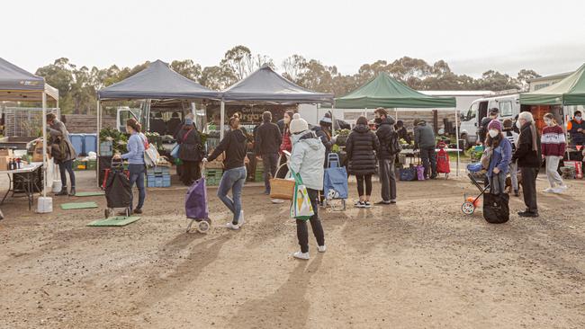 Melbourne Farmers Markets have continued through the pandemic as essential food retailers. Pictures show stallholders and shoppers adhering to strict social distancing guidelines and wearing masks. Picture: Melbourne Farmers Markets