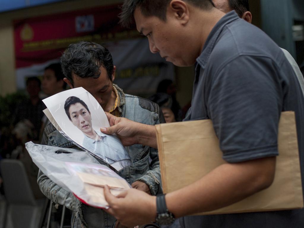 A relative holds a photo of a passenger of the crashed Lion Air plane at the police hospital in Jakarta. Picture: AP/Fauzy Chaniago