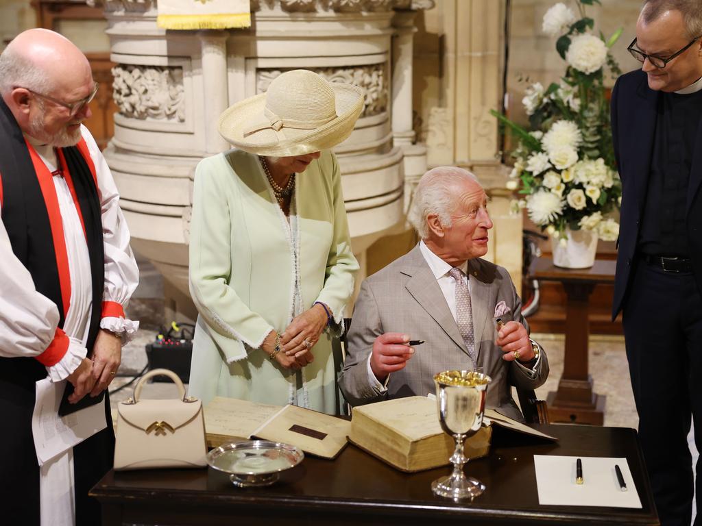 King Charles III and Queen Camilla sign the church bible. Picture: Rohan Kelly