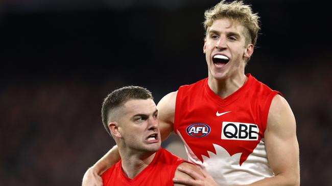 Dylan Stephens, pictured right with Tom Papley, is glad he stuck it out at the Swans despite several Victorian clubs trying to prise him out of the club last year. Picture: Phil Hillyard