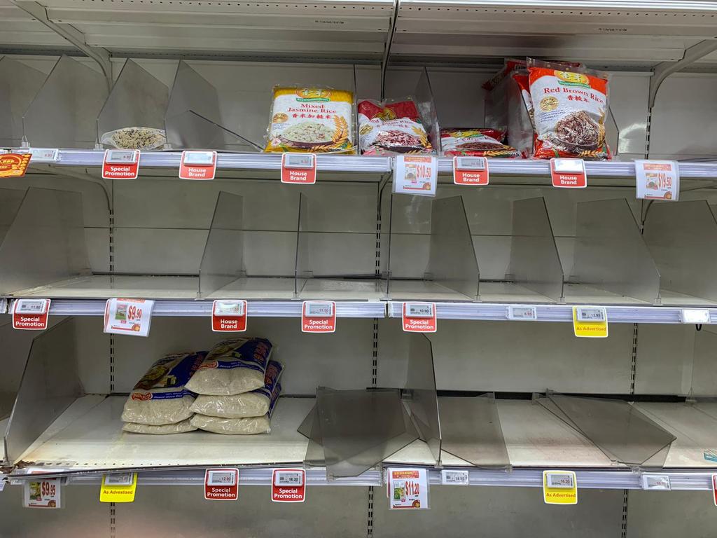 Empty shelves at a grocery store in Singapore after panic buying swept through the city after the government raised the alert level for a deadly novel coronavirus. Picture: Martin Abuggao/AFP