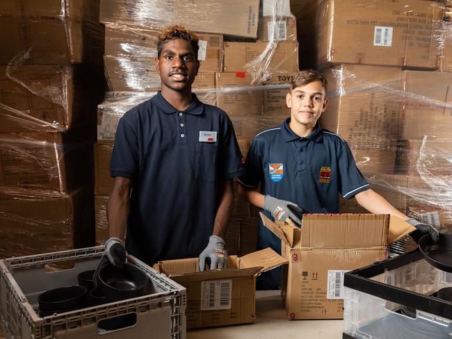 Clontarf Academy students Alonzo Nelson, 15, from Yirara College and Isaiah Miller,13, from Centralian Middle School at their part time job at KMart where they decant products to be put on the shelf. Photo: EMMA MURRAY