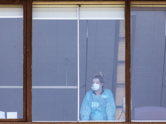 An NHS staff member looks from a top floor window at the St Thomas' Hospital in London, England. Picture: Getty Images