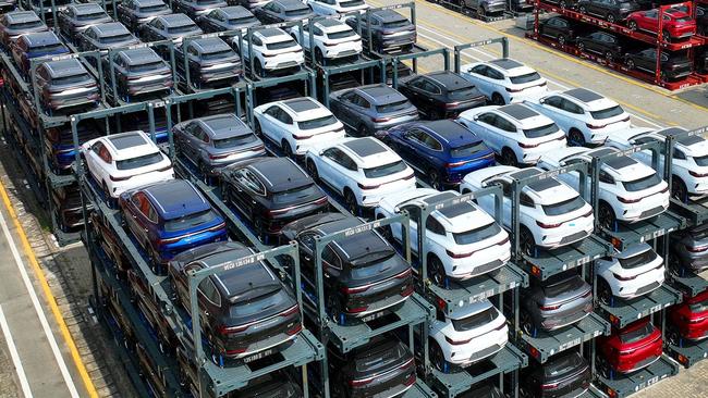 (FILES) This file photo taken on September 11, 2023 shows BYD electric cars waiting to be loaded on a ship are stacked at the international container terminal of Taicang Port at Suzhou Port, in Chinaâs eastern Jiangsu Province. China overtook Japan as the world's biggest vehicle exporter last year, data from the Japan Automobile Manufacturers Association (JAMA) showed on January 31, 2024. (Photo by AFP) / China OUT