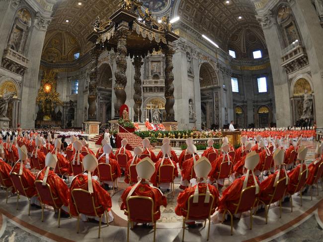 TOPSHOTS Cardinals attend a mass at the St Peter's basilica before the start of the conclave on March 12, 2013 at the Vatican. Cardinals moved into the Vatican today as the suspense mounted ahead of a secret papal election with no clear frontrunner to steer the Catholic world through troubled waters after Benedict XVI's historic resignation.The 115 cardinal electors who pick the next leader of 1.2 billion Catholics in a conclave in the Sistine Chapel will live inside the Vatican walls completely cut off from the outside world until they have made their choice. AFP PHOTO / GABRIEL BOUYS