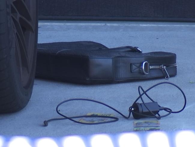 A laptop, and cash near a car in the driveway at the scene of the shooting of Mahmoud Abbas in Greenacre. Picture: NSW Police