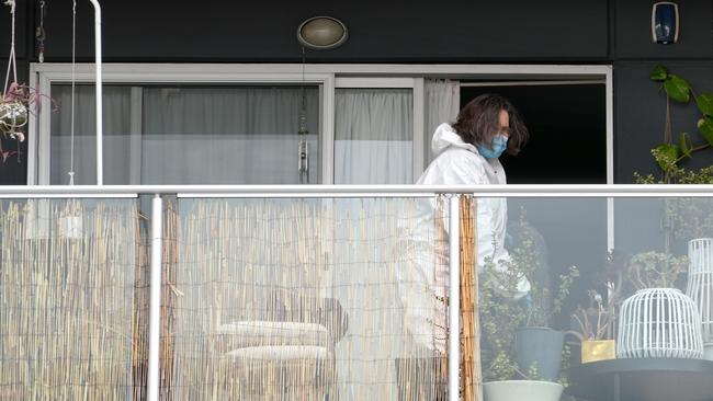 A forensic officer on the balcony of an apartment on Metro Parade in Mawson Lakes. Picture: Dean Martin