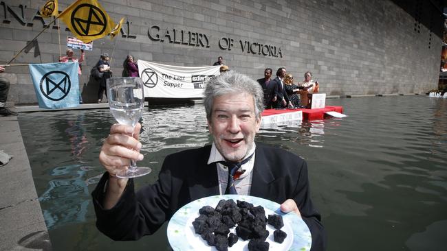 Protester Michael Staindl with a plate of coal during the rebels’ Last Supper protest in the NGV moat. Picture: David Caird