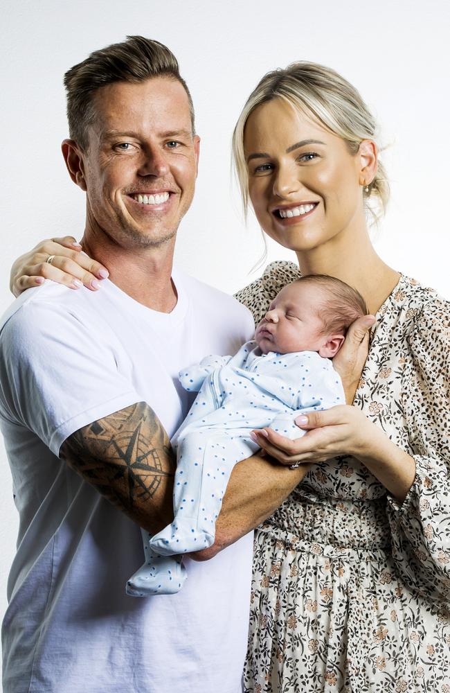 Supercars driver James Courtney and his wife Tegan pose together with their baby boy Kobe. Picture: Nigel Hallett