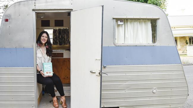 Writer Rose Hartley with her novel, Maggie's Going Nowhere. Picture: AAP/Roy VandervegT