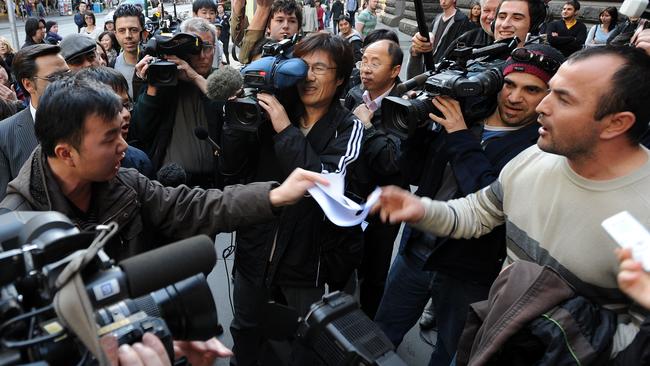 A Uighur protester confronts a Chinese protester outside the Melbourne Town Hall at the Melbourne International Film Festival, Saturday, August 8, 2009. Exiled Uighur leader Rebiya Kadeer and Festival Director Richard Moore will attend the official screening of "10 Conditions of Love." (AAP Image/Joe Castro) NO ARCHIVING