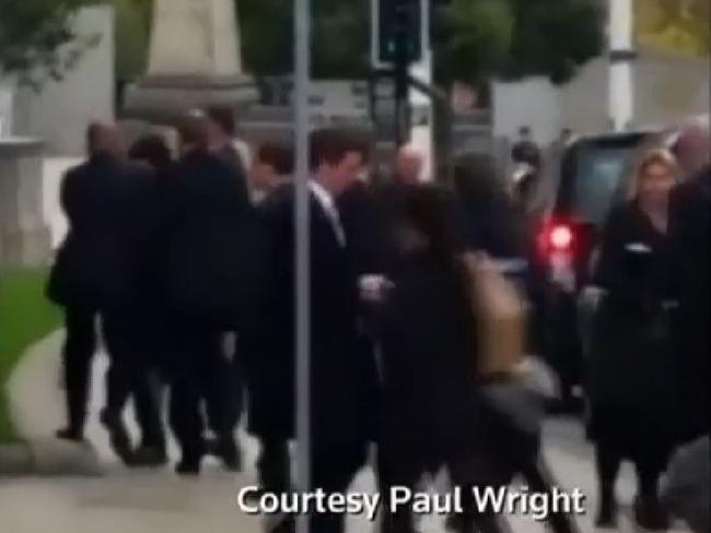A man runs into Prime Minister David Cameron.