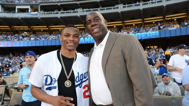 LOS ANGELES, CA – JULY 30: NBA player Russell Westbrook and Magic Johnson attend a game between the Los Angeles Dodgers and the New York Yankees on July 30, 2013 at Dodger Stadium in Los Angeles, Caifornia. (Photo by Jon Soohoo/Los Angeles Dodgers via Getty Images)