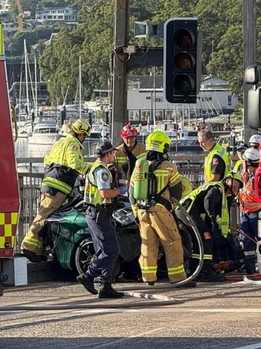 Emergency services surround one of the vehicles involved in the accident. Picture: www.mosmancollective.com