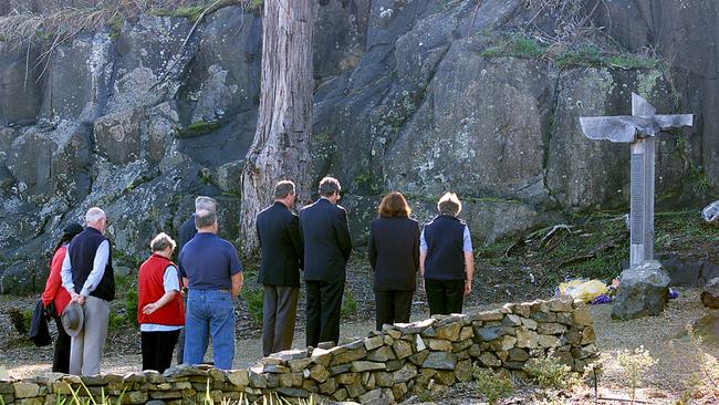 Mourners gathered behind the former Broad Arrow Cafe during an anniversary memorial for the massacre.