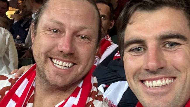 james pattinson and pat cummins watch the swans' prelim final win over port adelaide